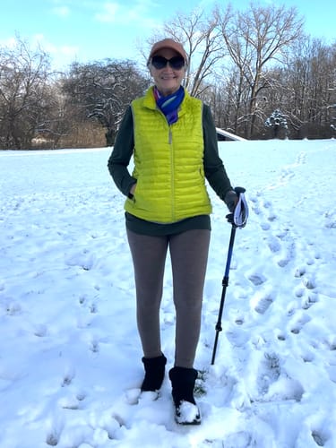 Reviewer standing in a snowy field wearing the Stella Petite leggings in Simply Taupe.