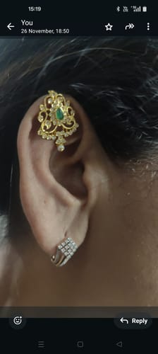 A reviewer wearing the 22k Gold Plated Tarika Amara Earcuff on the upper part of their ear, showing the intricate design.