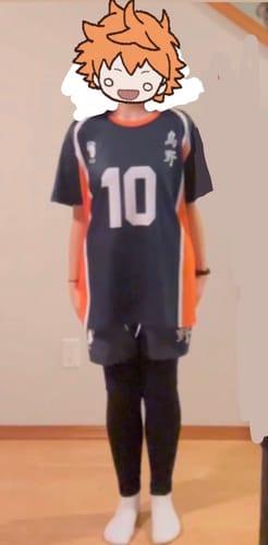 Reviewer standing forward wearing the dark Team Karasuno Beach Shorts with a matching jersey.