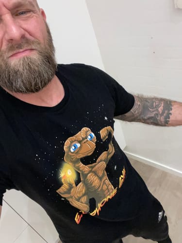 A customer wearing the black E.T. Phone Gym T-Shirt, showing the muscular E.T. graphic.