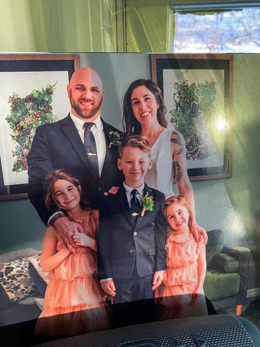 Customer showing the personalized album cover for their Custom Vinyl Record, featuring a lovely family portrait.