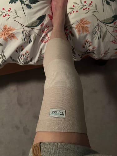 Customer wearing the Premium Bamboo Knee Sleeve on their leg, showing the comfortable fit.