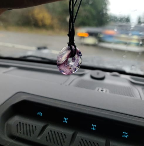 Customer's Taffy Confetti Halo Pendant with purple swirls hanging inside a car above the dashboard.