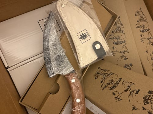 Customer's 5" Fixed Blade knife, wrapped for protection, with its sheath in a box.