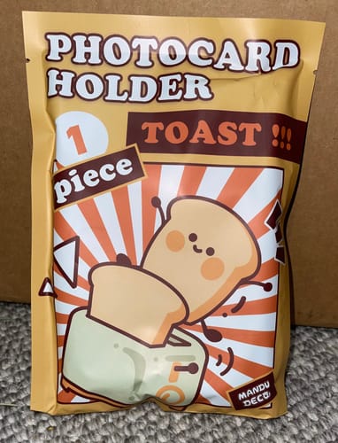 Packaging for the Butter Bread Photocard Holder showing a cartoon toaster graphic on the front.