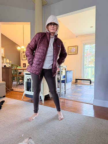 Reviewer standing indoors wearing the Piper Pocket Petite leggings in Bracken with a layered warm jacket.