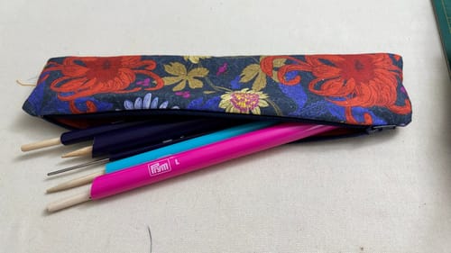 Customer's zippered case made from the floral fabric in the DIY Bag Bundle, holding sewing tools.