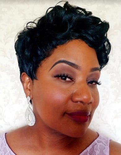 Reviewer in a close-up shot wearing the Keyshia wig, styled as a short, curly pixie cut.