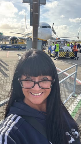 Customer smiling, showing off their long, dark hair after using the Instant Dye Shampoo.