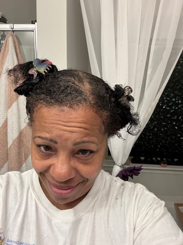 Reviewer showing her dark hair with gray roots before using the Instant Dye Shampoo.