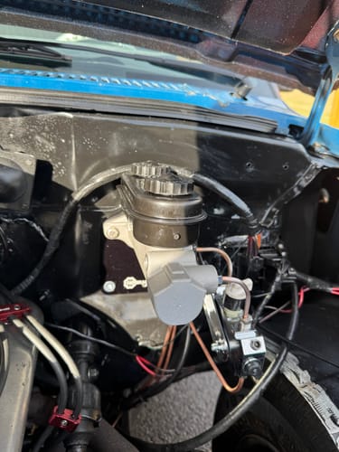 Customer's manual brake kit installed in a clean black engine bay, showing the new master cylinder.