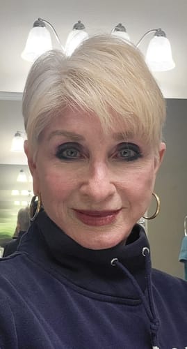 Customer showing her light blonde pixie cut after using the Instant Dye Shampoo to tone down her white hair.