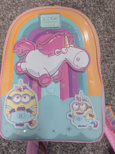 Customer's shiny Loungefly Minions Fluffy Unicorn backpack featuring a large unicorn applique and two costumed Minions.