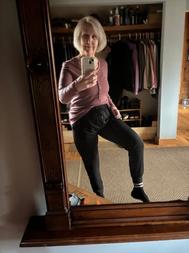 Reviewer taking a selfie while wearing the black Womens Varsity Mini Crew Socks with joggers.
