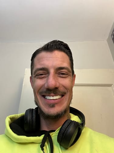 Customer smiling to show off their white, well-fitting Pop On Veneers.