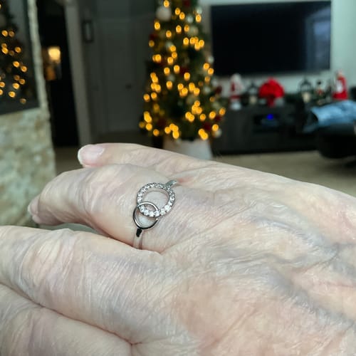 Reviewer's hand wearing the silver Forever Linked Ring. It shows two interlocking circles, one paved with sparkling stones.