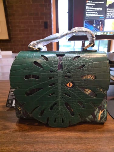 Customer photo review of Loungefly Jurassic World Jungle Velociraptor Glow Crossbody Bag