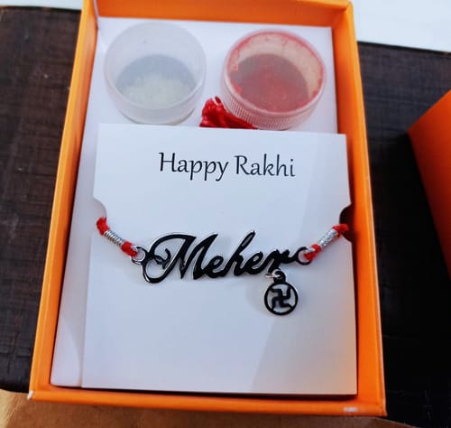 Customer photo review of Silver Personalised Name Swastika Chakra Rakhi