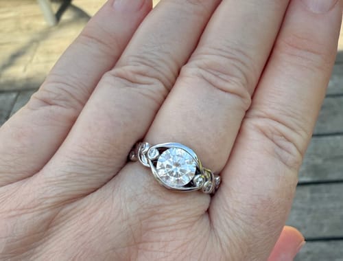 Customer photo review of Bezel Set Round Moissanite Scroll Accents Engagement Ring