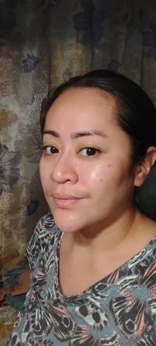 Customer selfie showing clear, smooth-looking facial skin in a review for the Bad Skin hydrating ampoule.