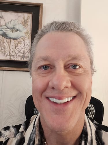 Customer smiling and showing a full, bright smile with their Pop On Veneers.