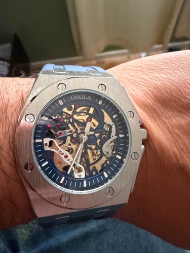 Customer's Lucky Fours® Prince Oak watch on their wrist, showing the blue skeleton dial and silver-colored case.
