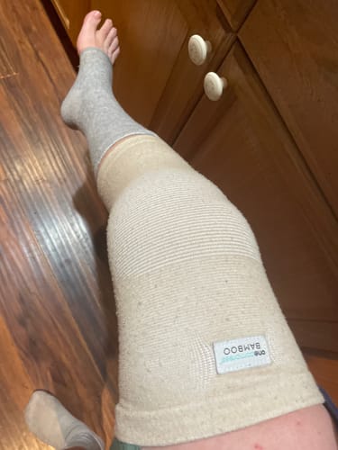 Customer wearing the well-worn Premium Bamboo Knee Sleeve on their leg, showing its fit and texture.
