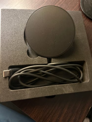 Customer's black SPOTMINDERS wireless charger and cable resting in its protective foam packaging.