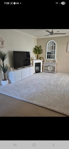 Customer's large Mellow Mat in Vanilla Cream covering the floor of a modern living room.
