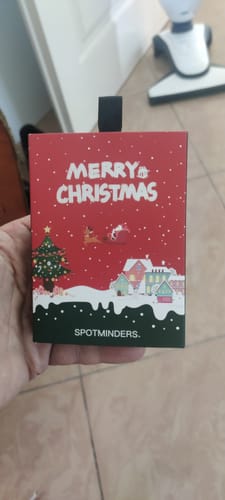 Customer holding the festive Christmas-themed box for the SPOTMINDERS. Tracking Card.