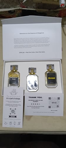 Customer's open Winter Box showing the three perfume bottles—Black Oud, Rumi, and a reflective one—neatly arranged inside.