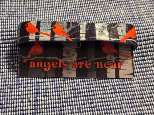 Reviewer's Angels Are Near Bracelet featuring a cardinal pattern, shown on its backing card.