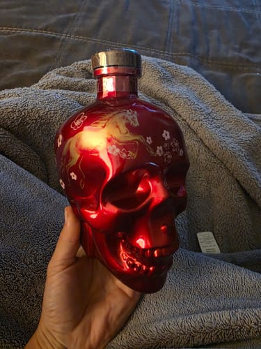 Customer holding the shiny red skull bottle of Crystal Head Vodka Year Of The Horse edition.