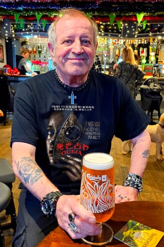 Reviewer wearing a black unisex t-shirt with a graphic for the movie 'Ouija' and Japanese text.