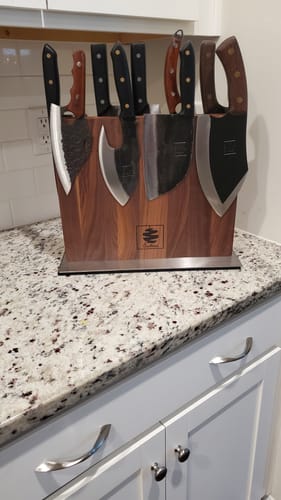 Customer's set of various knives from a Mystery Knife purchase, displayed in a wooden block on a countertop.