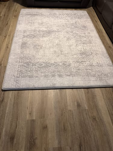 Customer's Silver Mist Mellow Mat with a distressed pattern laid out on a wooden floor in a living room.