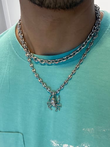 Customer wearing the silver 4mm Mini Infinity Chain as a choker, layered with another necklace and spider pendant.