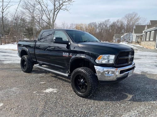 Reviewer's black Ram truck after installing a 4'' exhaust system using the stainless steel clamp.