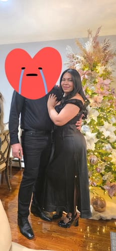 Customer wearing the black Roux Lace Satin Maxi Dress, showing off the lace cap sleeves and side slit while posing indoors.