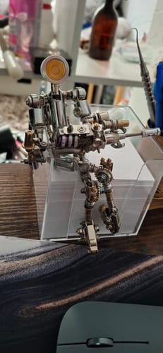 Reviewer's assembled metallic Terminator M model with a lamp for a head, standing on a desk.