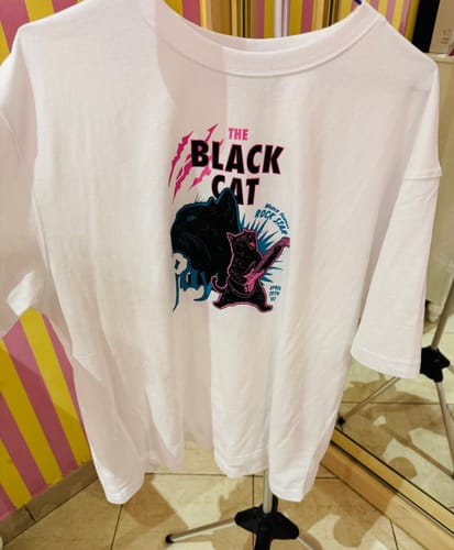 Customer's white Jay's Family T-shirt from Enhypen, featuring a black cat rockstar graphic.