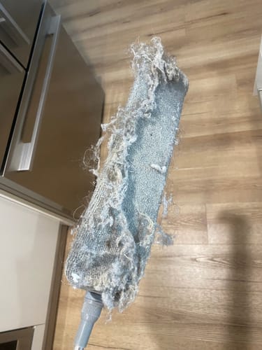 Customer's Koala Extendable Duster flat head covered in a thick layer of dust and hair after cleaning.