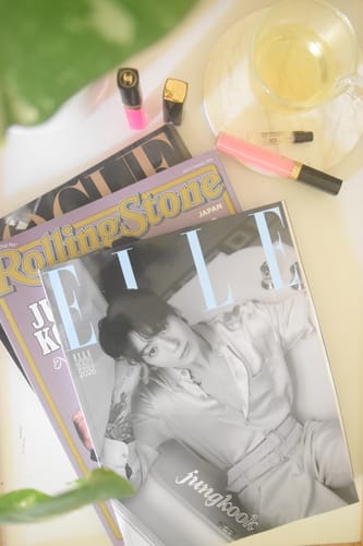 Customer's ELLE magazine with Jungkook on the cover, displayed with other magazines and beauty products.