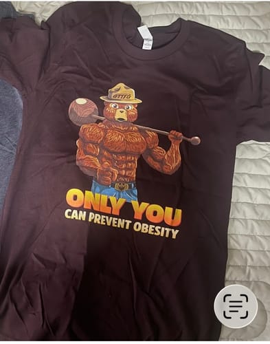 Customer's dark 'Only You Can Prevent Obesity T-Shirt' laid out, showing the full muscular bear graphic.