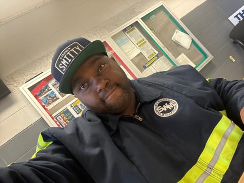 Reviewer wearing a Texas Blackout Plate Hat, a dark snapback with a custom 'SMITTY' patch.