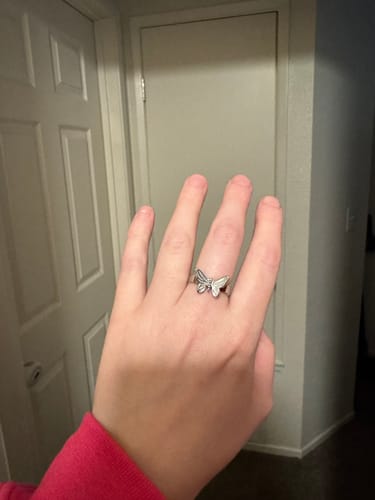 Customer showing their hand wearing the stylish Butterfly Ring on their middle finger.