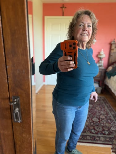 Reviewer in a mirror selfie wearing the blue Hadley Ribbed Crew top paired with jeans in a bedroom setting.