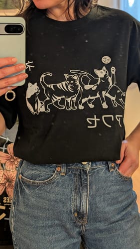 Reviewer wearing the black Playful T-Shirt tucked into jeans, showing a close fit.