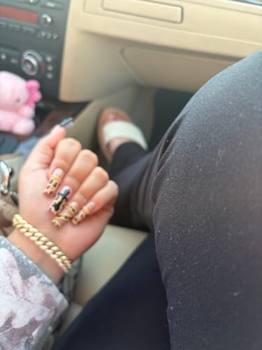 Reviewer wearing the gold Dime piece bracelet on their wrist while sitting in a car.