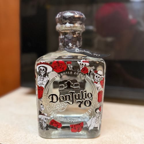 Customer's collectible Don Julio 70 tequila bottle with the vibrant Día de los Muertos artwork.